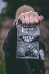  man holding contact coffee co coffee bag battle prep