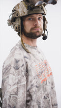 Load image into Gallery viewer, Portrait of a male model in the Contact Coffee camouflage top and helmet.
