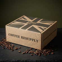 Load image into Gallery viewer, Inside the Coffee Resupply Gift Box: green M2A1 steel ammo tin and two matte black Contact Coffee mugs
