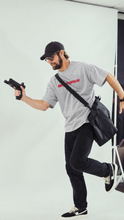 Load image into Gallery viewer, Luke wearing Black Coffee Bear Paw Heavyweight Tee
