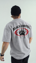 Load image into Gallery viewer, Luke wearing Black Coffee Bear Paw Heavyweight Tee
