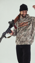 Load image into Gallery viewer, Luke wearing the Contact Coffee tree camo fleece hoodie
