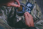  man making a coffee with coffee bag wearing camouflage