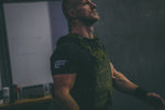  man in weighted vest wearing contact coffee co t-shirt