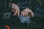  man opening coffee bag with a knife